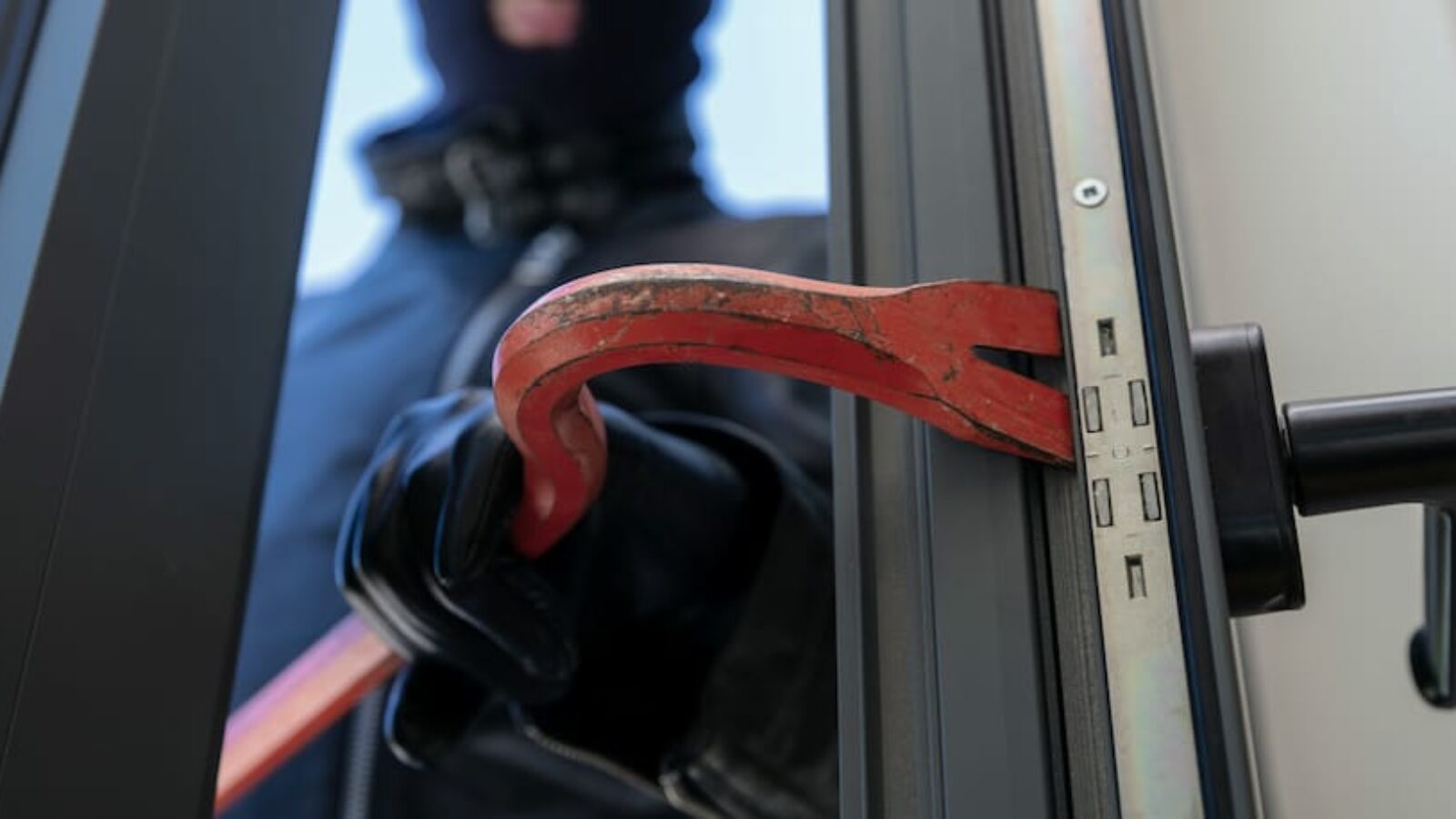 thief-in-balaclava-holding-a-crowbar-to-break-a-gl-2021-09-04-10-35-05-utc thief-in-balaclava-holding-a-crowbar-to-break-a-gl-2021-09-04-10-35-05-utc